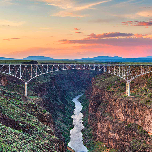 bridge across gorge and river at sunset | Bentley Systems | Infrastructure Engineering Software Company bridge across gorge and river at sunset