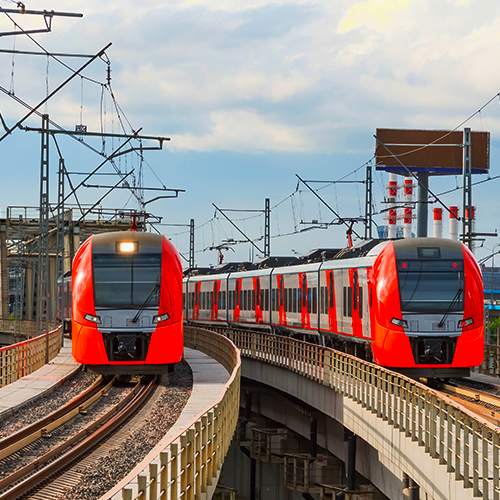 red metro trains coming towards you running on rail tracks | Bentley Systems | Infrastructure Engineering Software Company red metro trains coming towards you running on rail tracks
