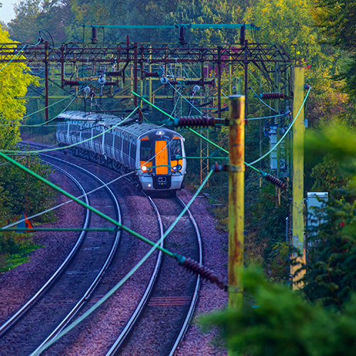 A green border with a train on the tracks. | Bentley Systems | Infrastructure Engineering Software Company A green border with a train on the tracks.